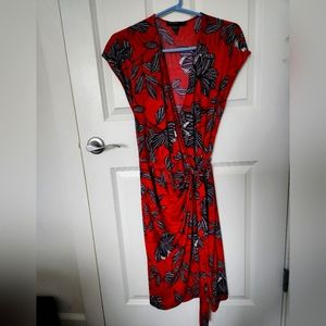 Maggy London size 12 short sleeved wrap dress in red and dark brown pattern.